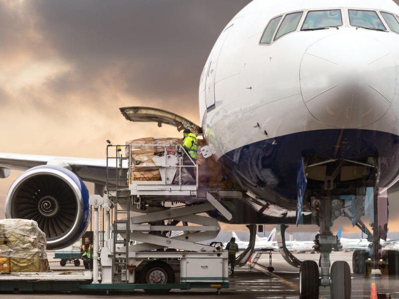 Airplane being loaded with cargo at an airport